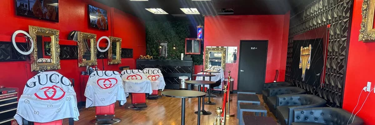 Modern barbershop interior with barber cutting client's hair